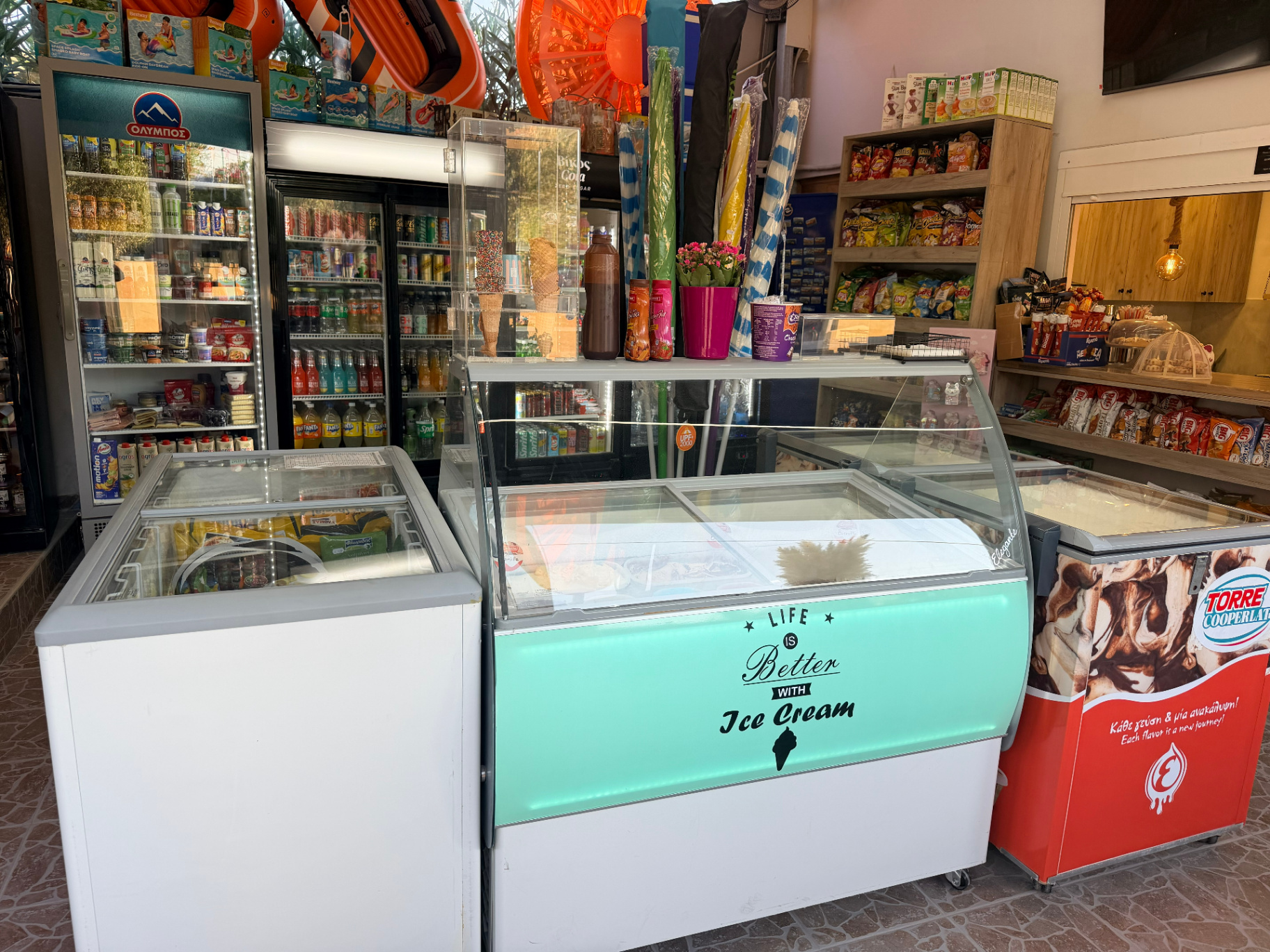 Ice cream display with gelato tubs and Torre Cooperlat freezer at AMOS SEASIDE Mini Market Marathi Beach Chania