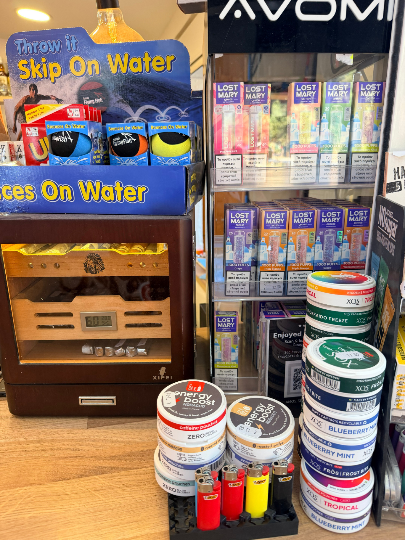 Kiosk essentials at AMOS SEASIDE Mini Market including lighters skip stones beach game and traveller essentials Marathi Chania