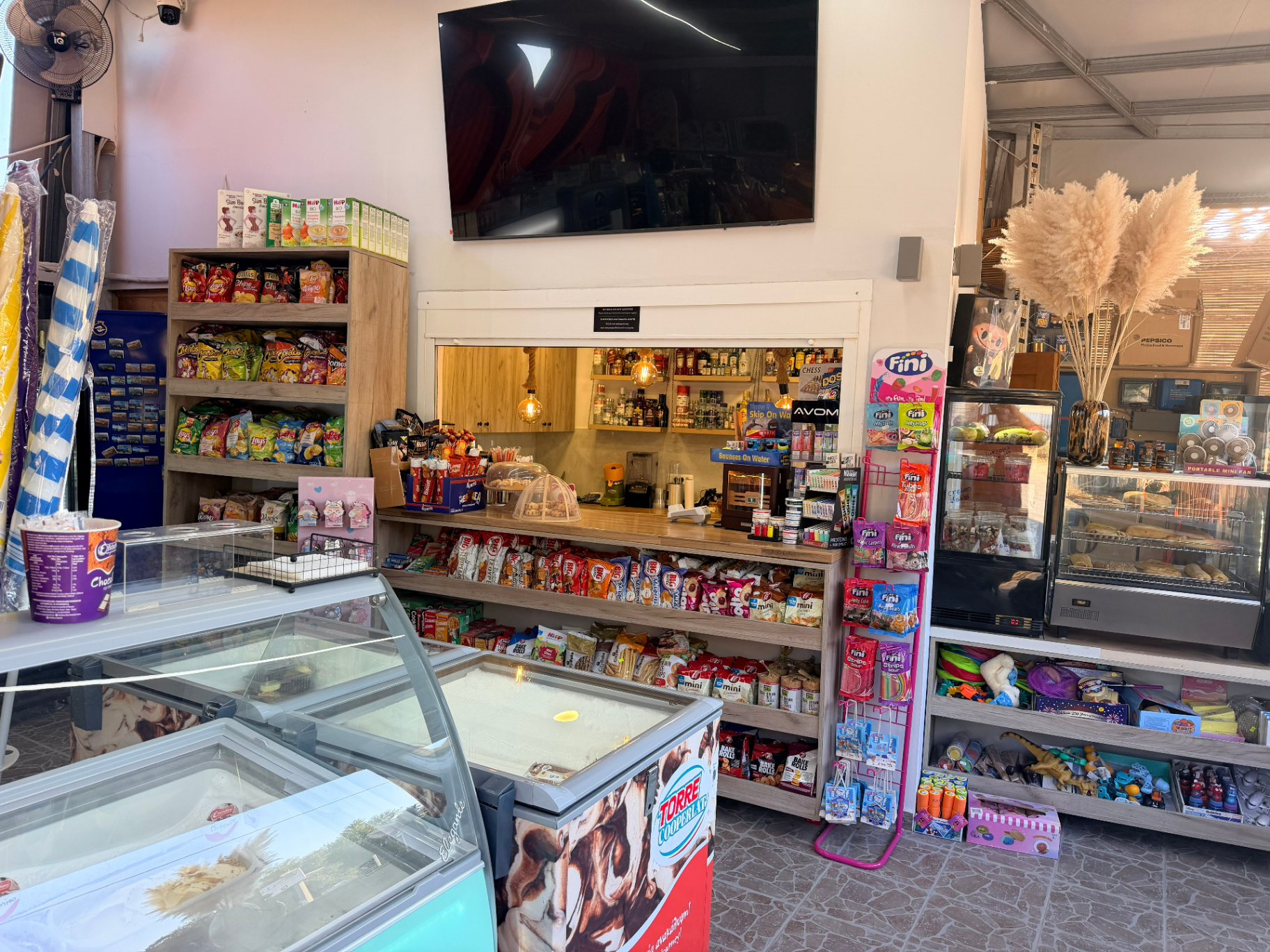 AMOS SEASIDE Mini Market interior with snacks chips sweets bakery and ice cream freezers near Marathi Beach Chania