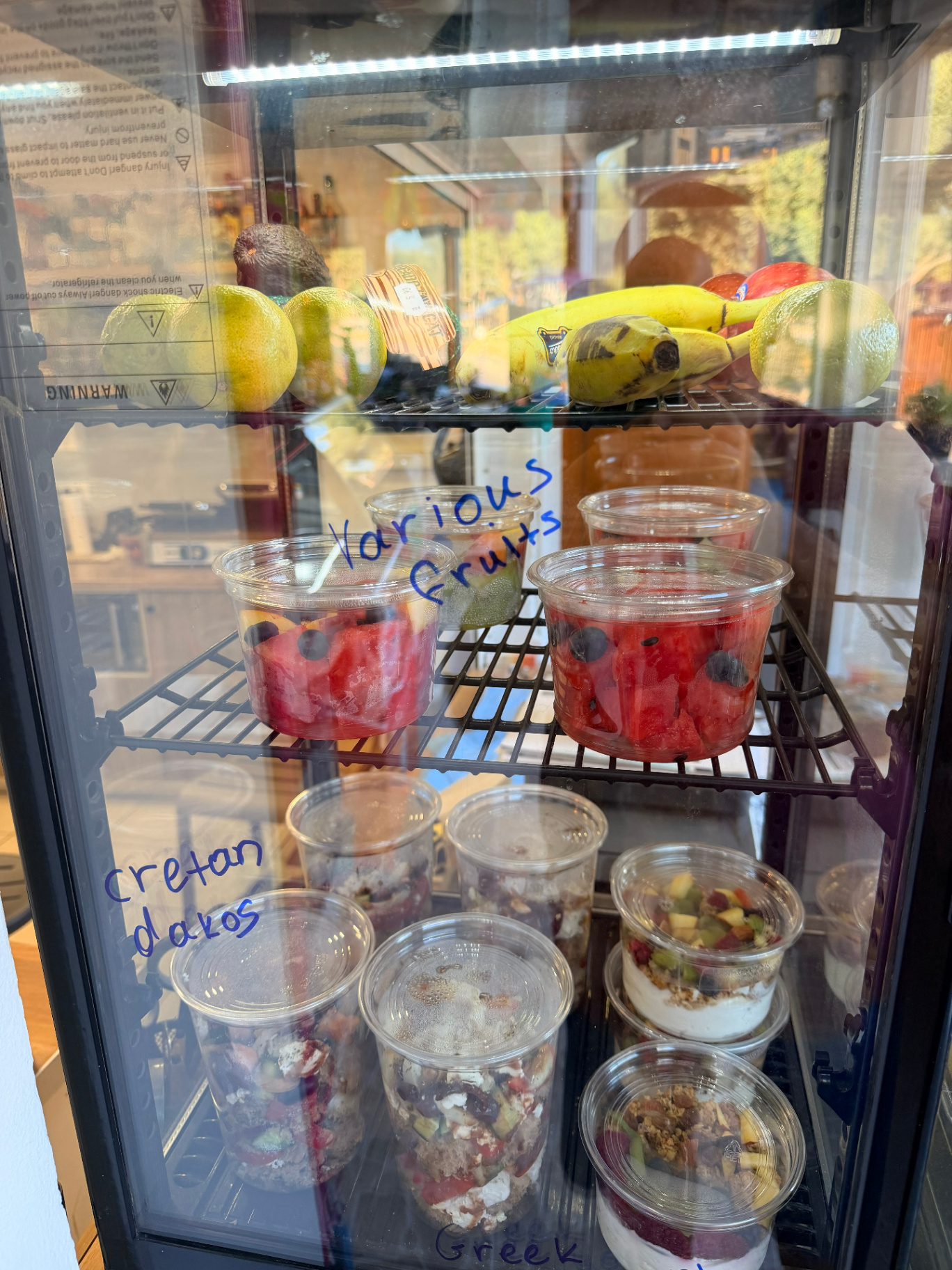 Cretan dakos, Greek yogurt and fresh fruit cups at AMOS SEASIDE mini market near Marathi Beach